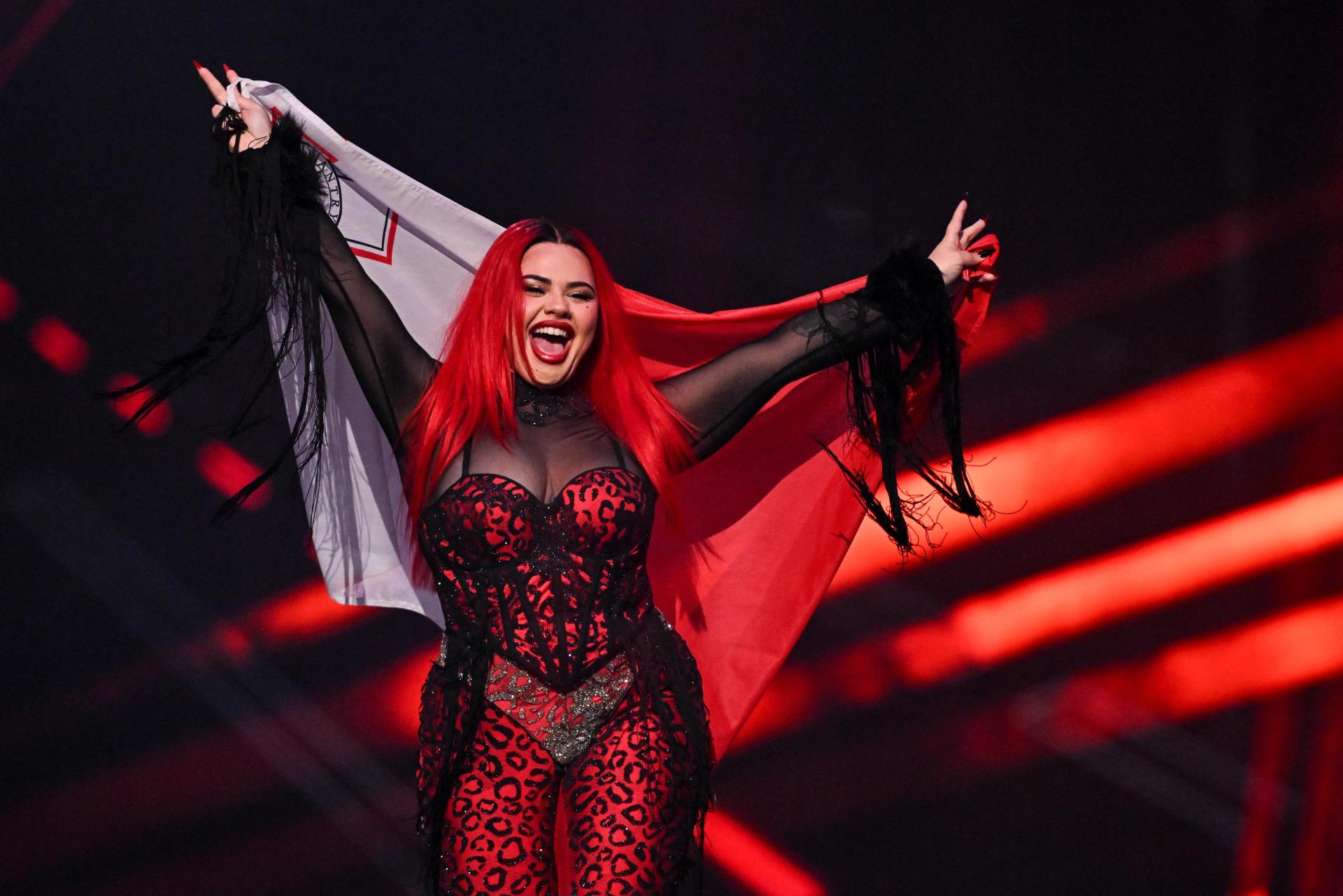 Miriana Conte proudly parading with the Maltese flag. Photo: AFP