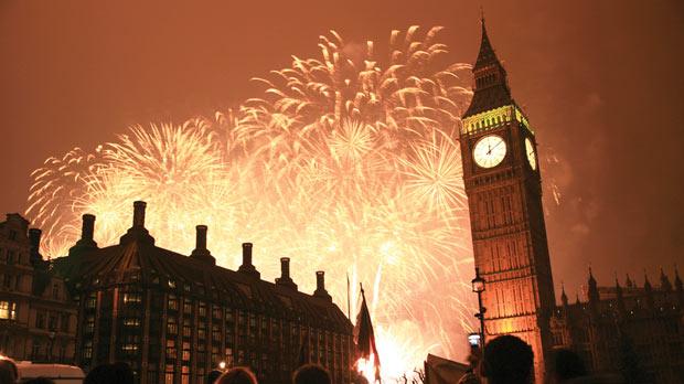 Big Ben chimes at midnight and street parties take place along the banks of the Thames in London.